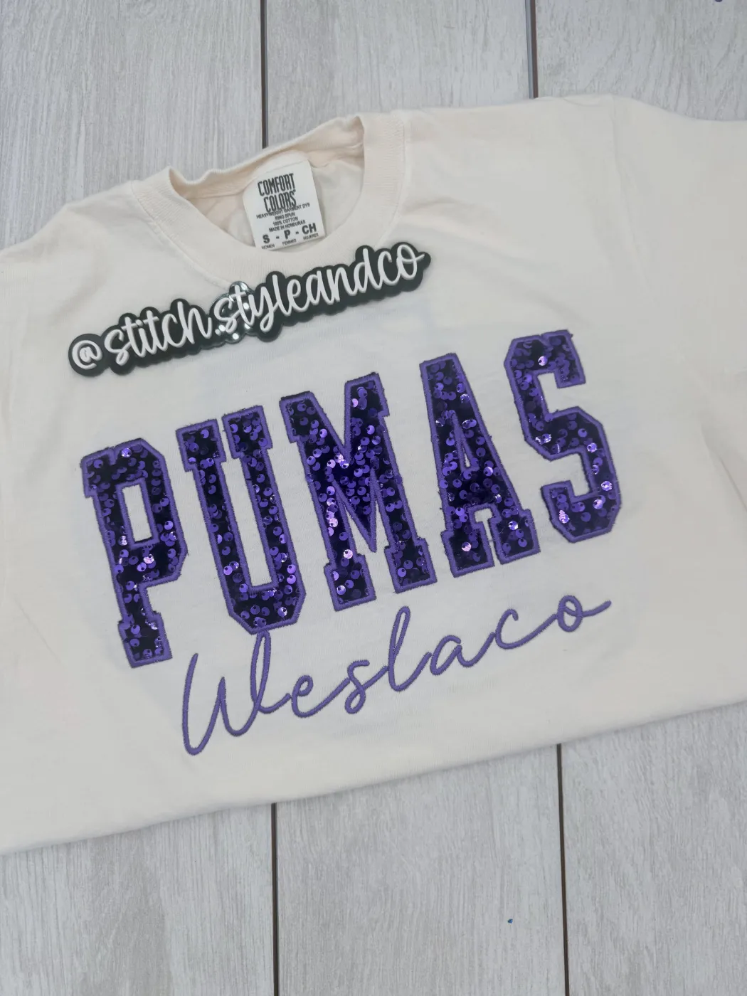Cream shirt with purple sequin PUMAS and Weslaco in script